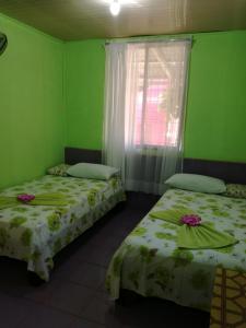 Ένα ή περισσότερα κρεβάτια σε δωμάτιο στο Hotel Margarita Sierpe