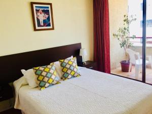 a bedroom with a bed with two pillows on it at Aconcagua Apartments in Santiago