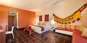 a hotel room with a bed and a bathroom at Hotel Waya Guajira By OxoHotel in Albania +38 photos
