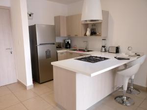 a kitchen with a white counter top and a refrigerator at Boutique Apartment Carso Alameda-1102 in Mexico City