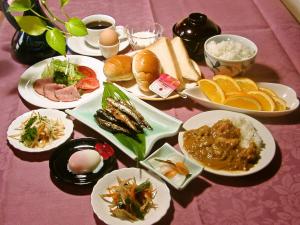 a table with plates of food on a pink table at Asano Hotel in Kitakyushu