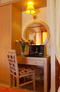 a room with a desk with a laptop and a mirror at Acropole Delphi City Hotel in Delphi