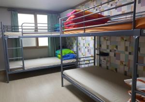 Postel nebo postele na pokoji v ubytování K Guesthouse