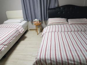 Postel nebo postele na pokoji v ubytování K Guesthouse