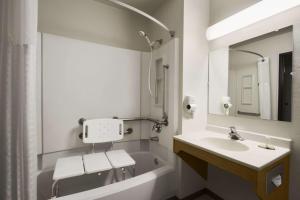 a bathroom with a tub, sink, mirror and bathtub at Super 8 by Wyndham Port Angeles at Olympic National Park in Port Angeles