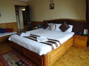 Voodi või voodid majutusasutuse Jain Group Hotel Royal Residency toas