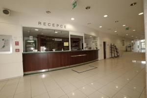 a large lobby with a reception desk in a building at Kolej Akademie in Brno