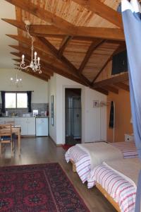 a bedroom with a large bed and a kitchen at Off The Square in Safed