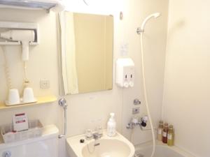 a bathroom with a sink and a mirror at Hotel Paco Obihiro Chuo in Obihiro +35 photos