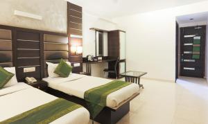 מיטה או מיטות בחדר ב-Hotel Apple Inn Vapi