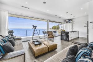 a living room with a view of the ocean at Aloha Waterfront Properties in Robe