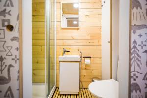 a small bathroom with a toilet and a sink at Vaattunki Wilderness Resort in Rovaniemi