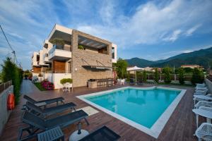 a villa with a swimming pool and mountains in the background at Chrysalis studios in Stavros
