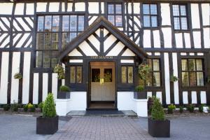 a black and white building with a door at The Manor Elstree in Elstree