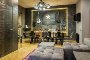 a living room with a table and a dining room at Design-hotel Rooms and Rumors in Odesa