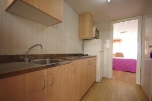 a kitchen with a sink and a counter top at Apartamentos Los Pinos in Calpe