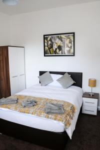 - une chambre avec un grand lit blanc et une couverture dans l'établissement Parks Nest 2, à Hull