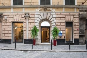 an entrance to a building with two potted plants at Best Western Porto Antico in Genoa