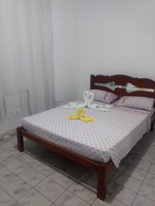 a bedroom with a bed with a white andophen at Hotel Britânia in Ilhéus