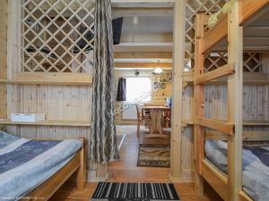 a bedroom with two bunk beds and a desk at Cottage Tatry so saunou in Tatranska Strba