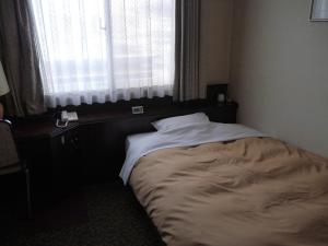 Postel nebo postele na pokoji v ubytování Hotel CROWN HILLS MIYOSHI