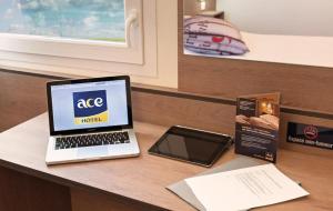 a laptop computer sitting on top of a desk at Ace Hôtel Le Mans in Saint-Saturnin