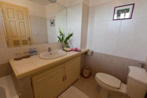 a bathroom with a sink and a toilet and a mirror at Grand Residence in Phnom Penh