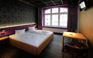 a bedroom with a large bed and a window at Singer109 Hostel, Hotel & Apartment in Berlin +158 photos