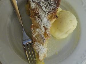a plate of food with a fork and ice cream at Affittacamere Porticciolo in Castelnuovo del Garda