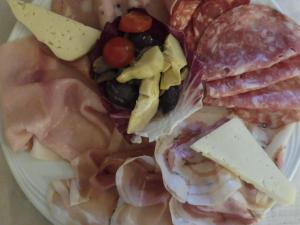 a plate of food with different types of seafood at Affittacamere Porticciolo in Castelnuovo del Garda