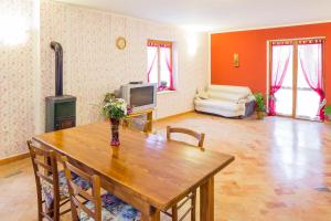 a living room with a wooden table and a television at Mon Perin Castrum - Apartman Valentina in Bale
