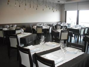 a dining room with tables and chairs with wine glasses at Muralha de Caminha in Caminha