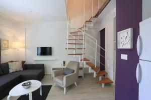 a living room with a staircase and a couch at Alp Suites Lavanta in Akyaka