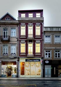 a large brick building with windows on a street at Mercado dos Poetas – Tourism Apartments in Porto