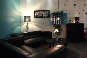 a living room with a leather couch and a table at Hotell Centralstation in Uppsala