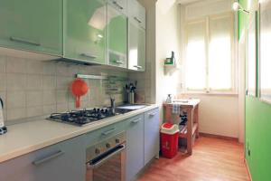 a kitchen with green cabinets and a counter top at Appartamento centro storico corso magenta cadorna in Milan