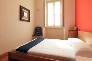 a bedroom with a bed and a window and a chair at Appartamento centro storico corso magenta cadorna in Milan