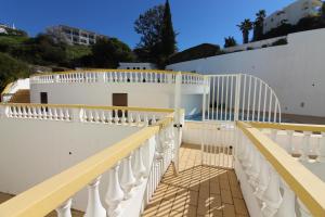 a white balcony with white railings on a building at Cardoso Beirao in Carvoeiro