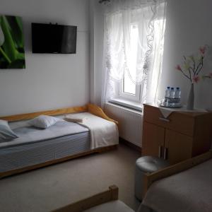 Postel nebo postele na pokoji v ubytování Biesiadny Dworek