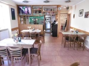 a dining room with tables and chairs in a restaurant at Gasthaus ,,Zum schwarzen Bär" in Güsten