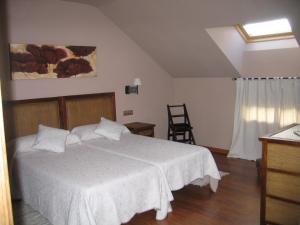 A bed or beds in a room at Hotel Rural Robles