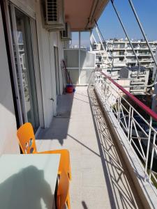 a balcony on a cruise ship with a table and chairs at Top Floor Apartment in Komotini