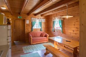 a living room with a couch and a table in a cabin at Lomahyppäys in Naantali