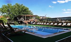 a swimming pool with lounge chairs and a swimming poolvisor at Gurkan Apart Hotel in Dalyan