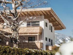 a house with a wooden roof at SonnenNEST mit SAUNA in Mayrhofen