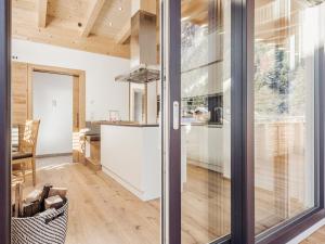 a kitchen and dining room with sliding glass doors at SonnenNEST mit SAUNA in Mayrhofen +9 photos