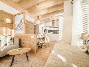 a living room with a couch and a table at SonnenNEST mit SAUNA in Mayrhofen