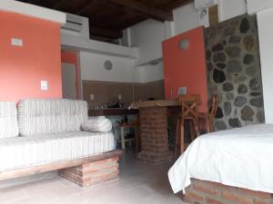 a living room with a bed and a fireplace at Altos del Molle SF in San Francisco del Monte de Oro