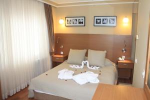 a hotel room with a bed with towels on it at Hotel Buyuk Sahinler in Istanbul