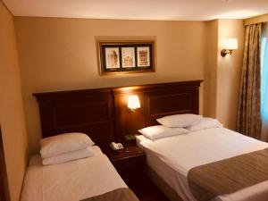 Cama ou camas em um quarto em Hotel Perula & SPA
